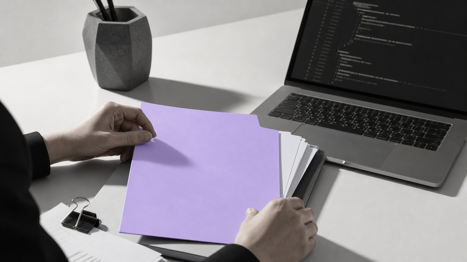 A workspace showing the legal and technical components of tokenization, with documents and code representing the dual requirements of asset structuring