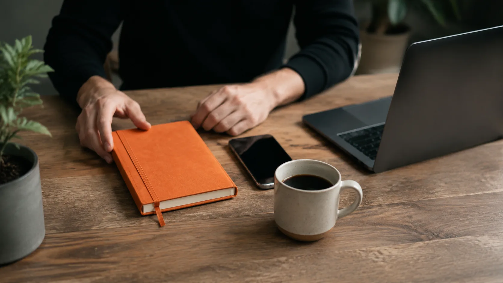The essential beginner affiliate marketing setup: a niche notebook, smartphone, coffee, and laptop with analytics visible.